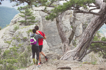 Naklejka premium Couple of hikers looking from mountain