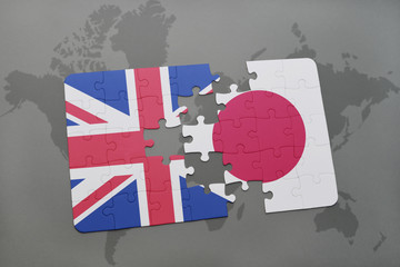 puzzle with the national flag of great britain and japan on a world map background.