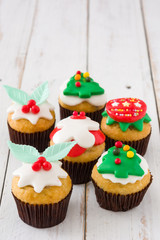 Christmas cupcakes on white wooden table background

