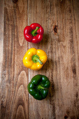 Colorful peppers on rustic wooden table