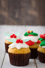 Christmas cupcakes on white wooden table background

