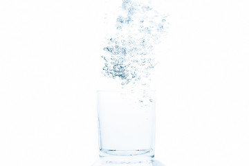 Glass of water with emerald bubbles