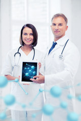 two doctors showing tablet pc with molecules