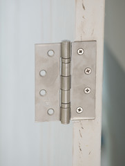 Fototapeta premium stainless door hinges on a door