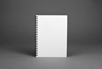 Blank spiral notebook on gray background
