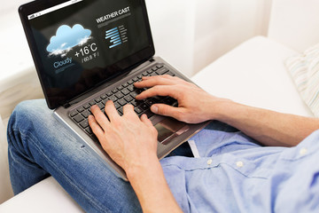 Fototapeta premium close up of man typing on laptop computer at home