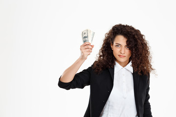 Picture of seriously curly business girl holding money