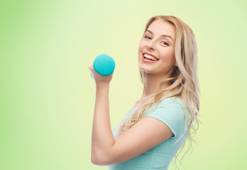 smiling beautiful young sporty woman with dumbbell