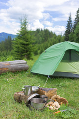 Camping in a mountainous area with cooking equipment.