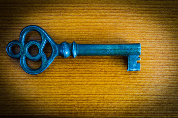 Antique skeleton key vignette on woodgrain background