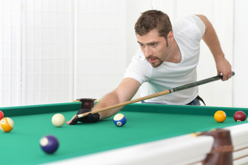 man playing billiards in  billiard club