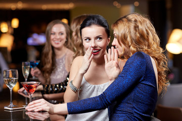 happy women with drinks at night club