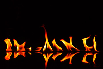 Fire flames and shadow on black background.