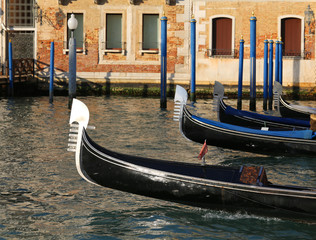 Fototapeta na wymiar Venetian gondolas sailing the waters of the Grand Canal in Venic