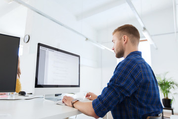 Naklejka na ściany i meble creative man or programmer with computer at office