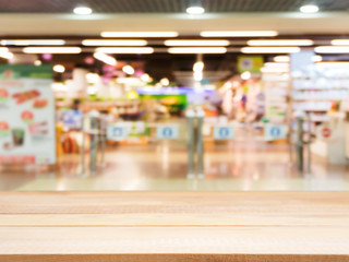 Wooden empty table in front of blurred supermarket