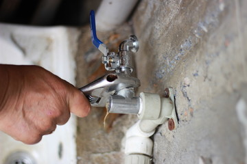 Plumber screwing plumbing fittings
