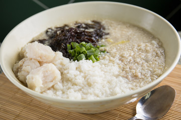 Traditional chinese bowl of porridge on the table in restaurant