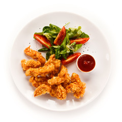 Fried chicken nuggets and vegetables