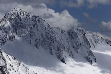 Fototapeta na wymiar Snow-covered mountain tops. Russia, Caucasus.