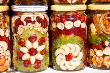 Homemade honey with dried fruits and nuts on the market