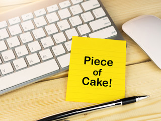 Piece of cake on sticky note on work desk