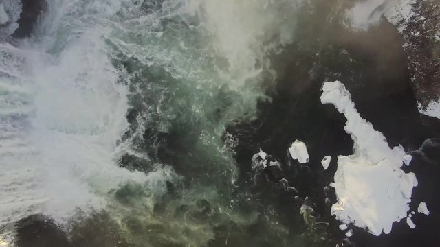 Aerial ultra high definition video of Godafoss waterfall in Iceland. Footage shot in winter with snow on the ground. Shoot with a DJI phantom pro. Drone travels downriver and over the waterfall itself