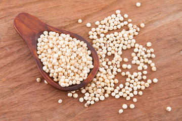 gluten free grains, millet, sorghum and linseed spoon on wooden natural background