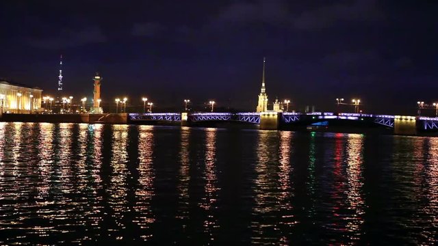 Night view of the University embankment of St. Petersburg through the Neva River- Peter and Paul fortress Palace bridge Vasilievsky island.