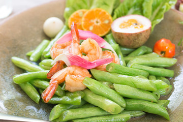 Fried long beans with prawns  with  slices of orange and passion