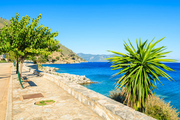 Promenade along a beautiful sea on coast of Kefalonia island in Agia Efimia, Greece