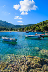 Fishing boats on turquoise sea in mountain landscape of Kefalonia island, Greece