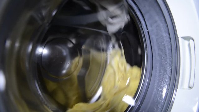 spinning drum of the washing machine with laundry