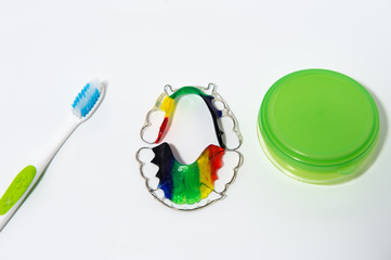 close up of colorful dental braces isolated on white background