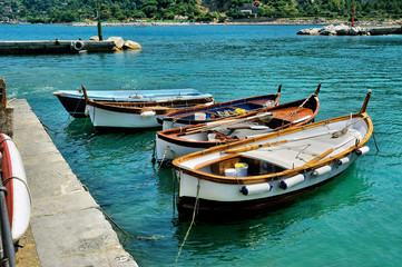 Fototapeta na wymiar Fishing boats on blue water in Cinque Terre