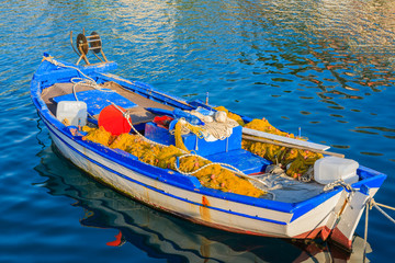 Traditional Greek fishing boat on sea water in Agia Efimia port, Kefalonia island, Greece