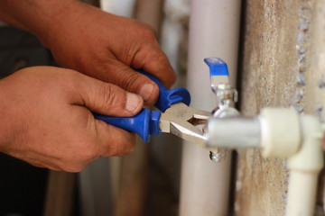 Plumber screwing plumbing fittings