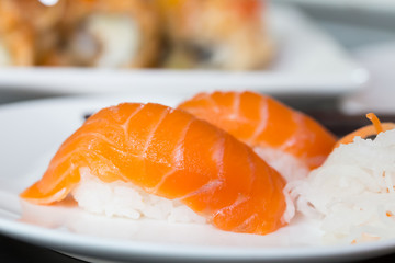 Sushi salmon on white plate with chopstick
