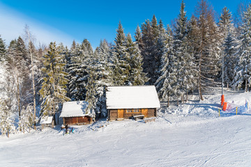 Mountain huts in Wierchomla ski area on sunny winter day, Poland