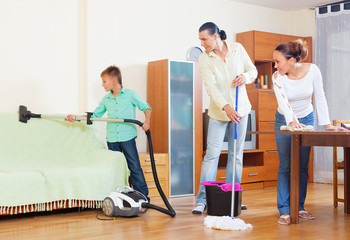 Ordinary family of three  doing house cleaning