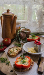 toast with cheese and meat on top of scrambled eggs with herbs
