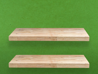 two wooden shelve on green wall
