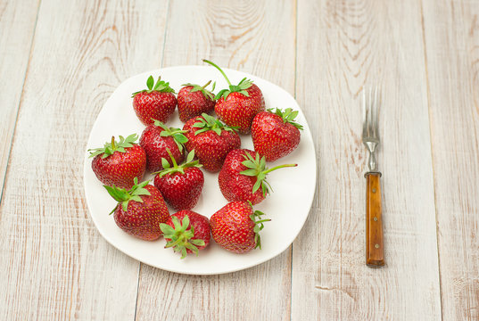 Ripe strawberry fruits on a white  plate