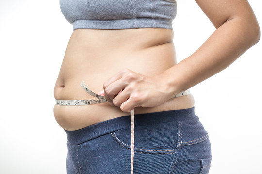 overweight woman with tape measure around waist