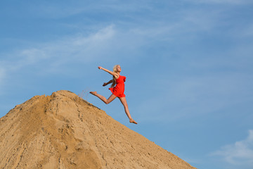 Happy girl jumping on the beach 