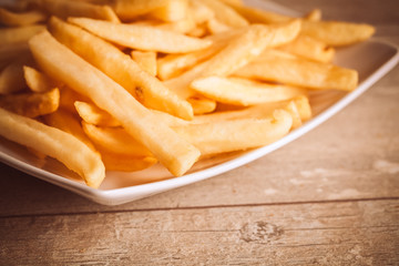 Potatoes fries on wood board