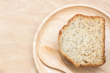 Sweet cake in wooden plate with spoon