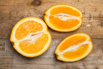 Fresh orange on rustic wooden table. Top view.