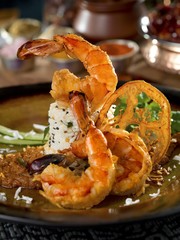 Fried shrimp with rice on plate in restaurant