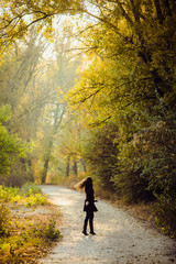 girl walks in beautiful autumn park